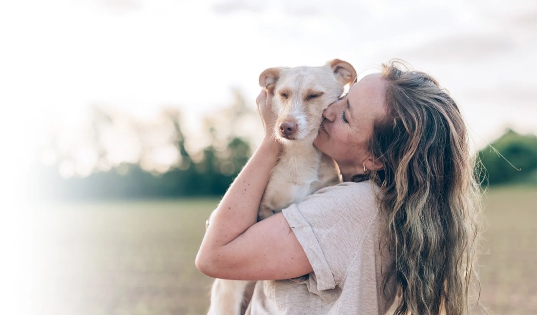 An adult dog and owner outdoors